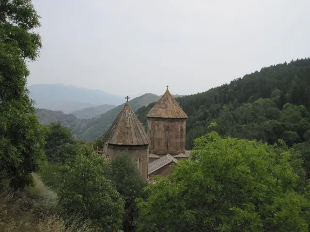 The domes of Sapara Monastery above the forest in the gorge